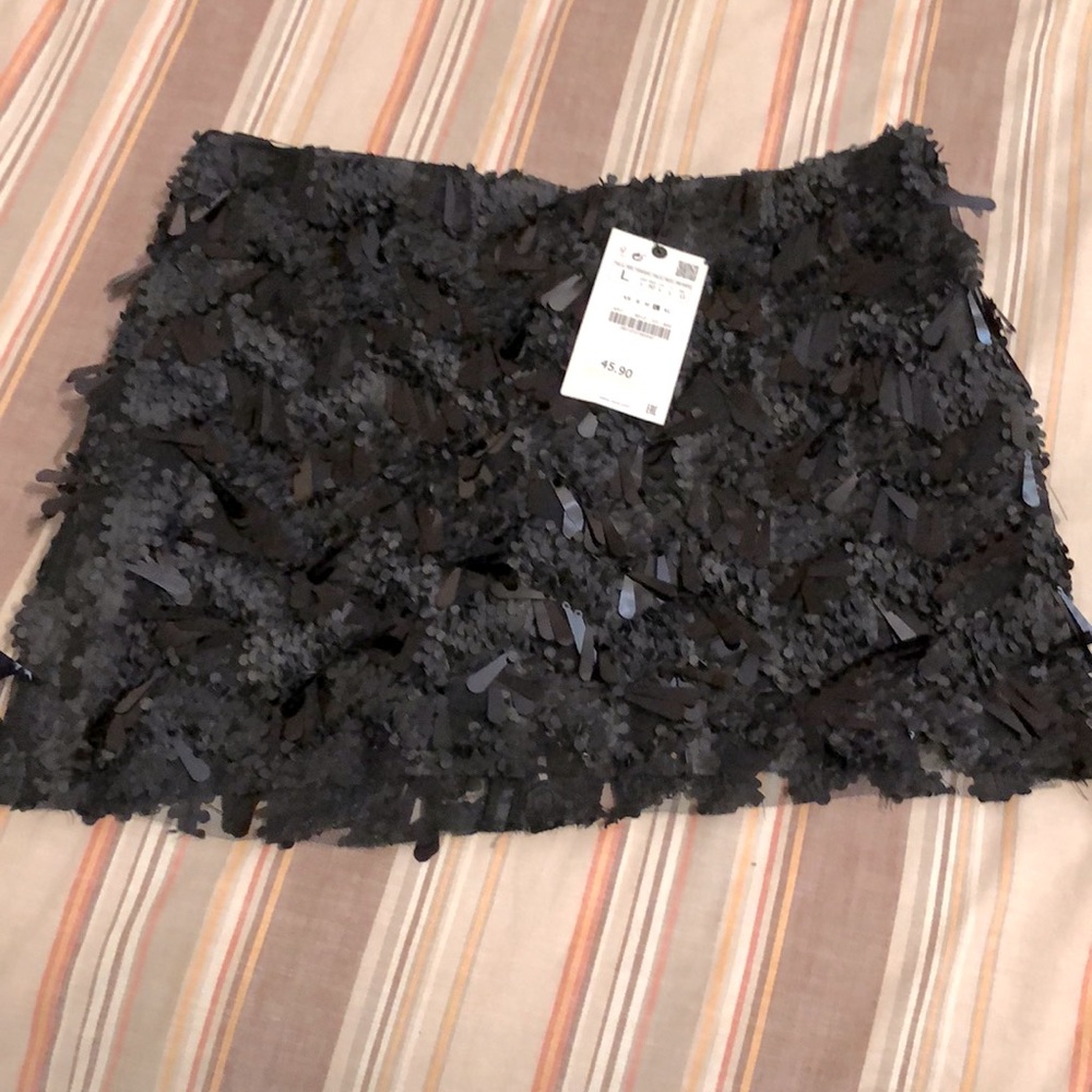 Black sequin skirt,zips up the back (hidden zipper),built in shorts under skirt